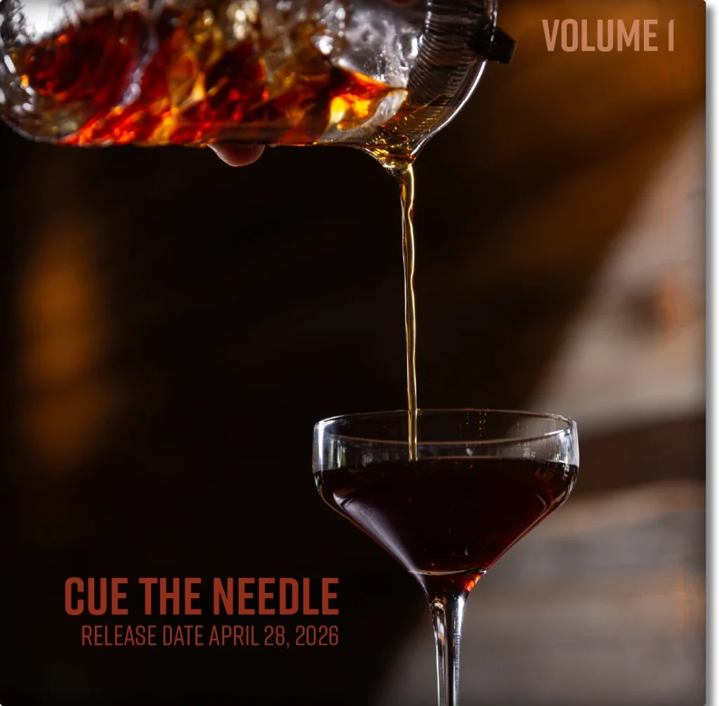 After-dinner cocktail being poured into a glass on a record sleeve-style backdrop featuring “Cue the Needle” and South Main Social’s April 28, 2026 opening.